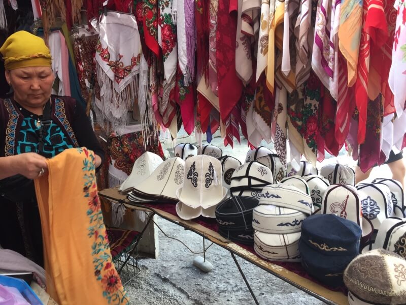 Typical clothes market in Kyrgyzstan, with kalpaks for sale, traditional hat of the country
