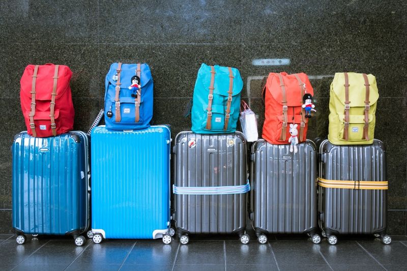 Row of suitcases with carry-on baggage sitting on top