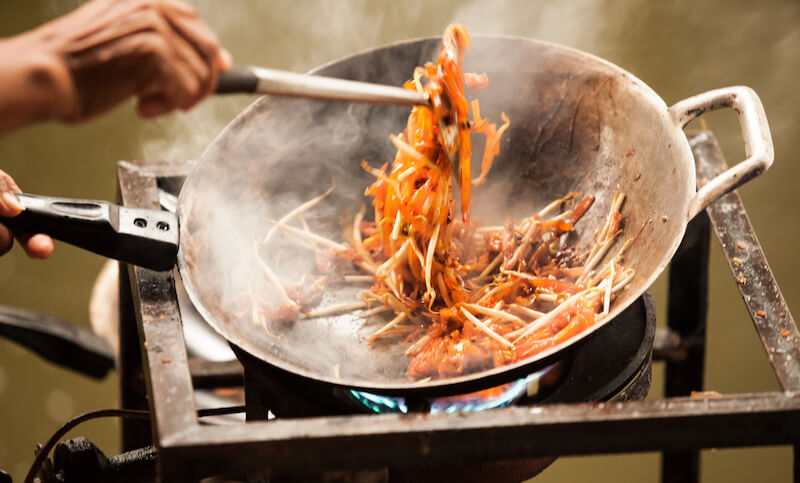Bangkok must eat street foods! Being fried in a wok