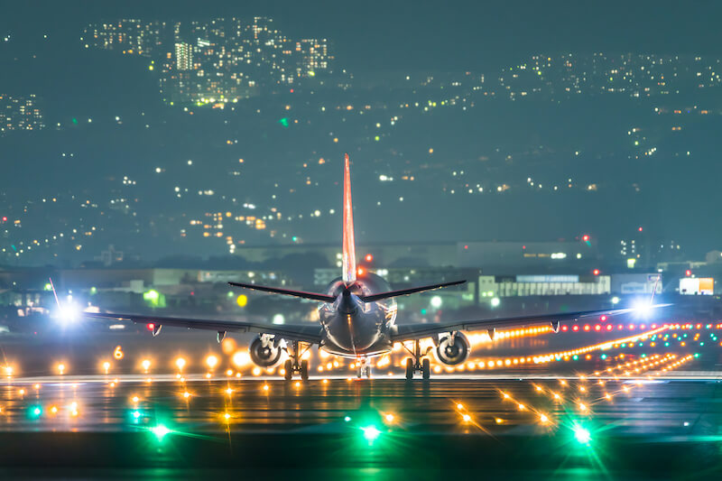 Flight taking off on a runway at night