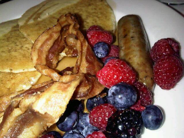 Food tourism USA - pancakes with bacon, sausages and fruit
