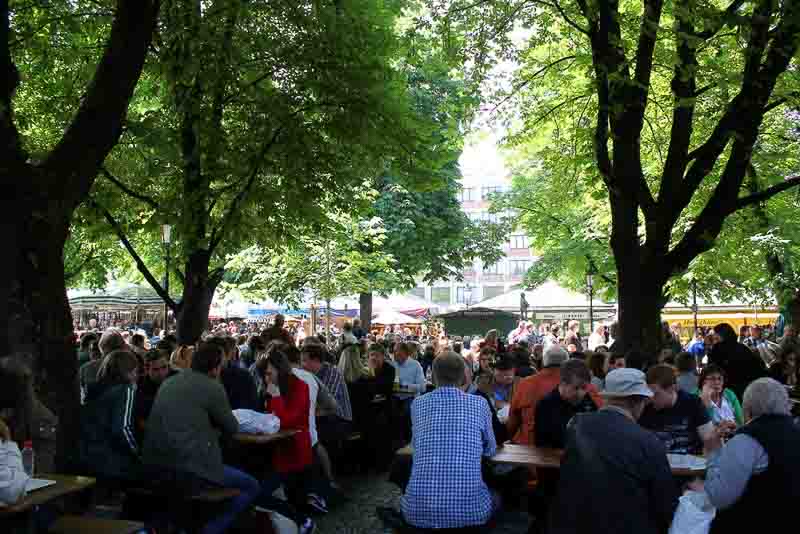 Eating at the Viktualienmarkt, one of the fun things to do alone in Munich