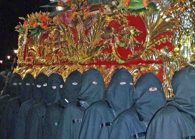 Hooded men taking part in a parade and celebrations of Easter weekend in Leon, Castile, Spain